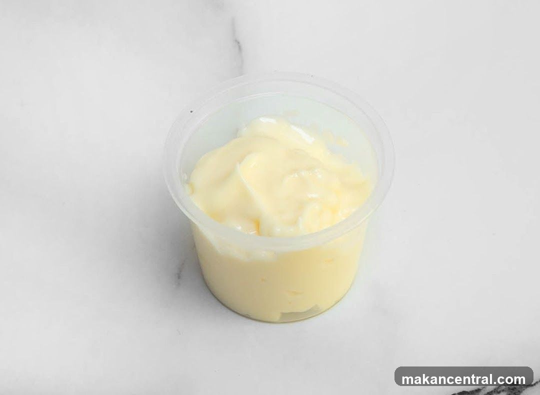 Mayonnaise in a clear plastic cup