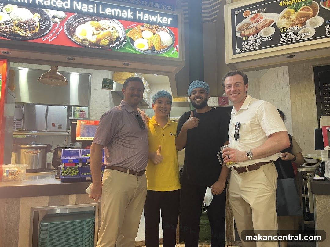 Four Men Posing at a Food Stall