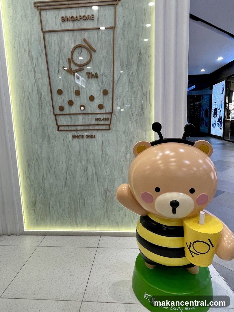 Bear mascot in front of KOI The Singapore storefront