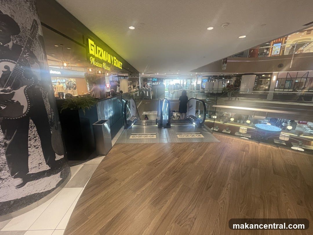 Mall interior with escalators and storefronts