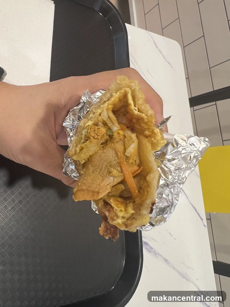 Hand holding a wrap with filling