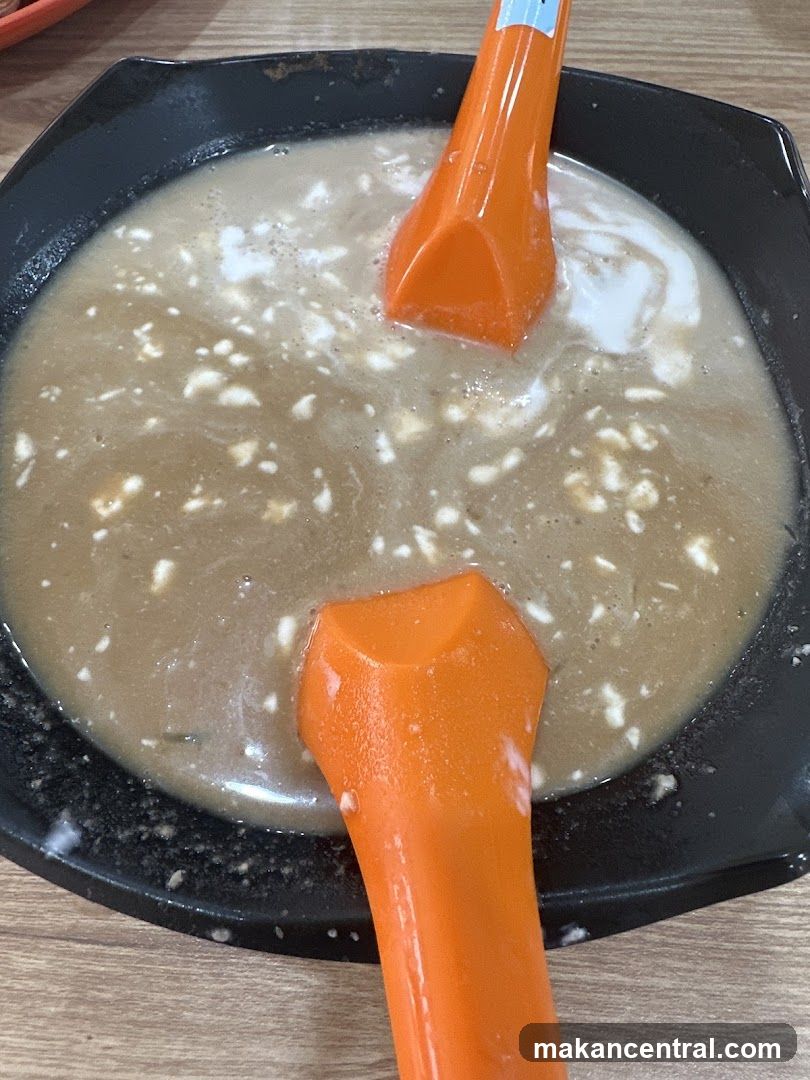 Bowl of Soup with Spoons