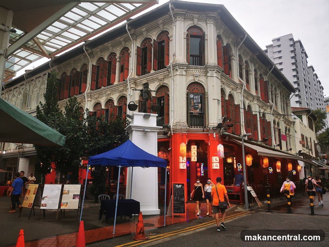 Corner building with red accents and awnings