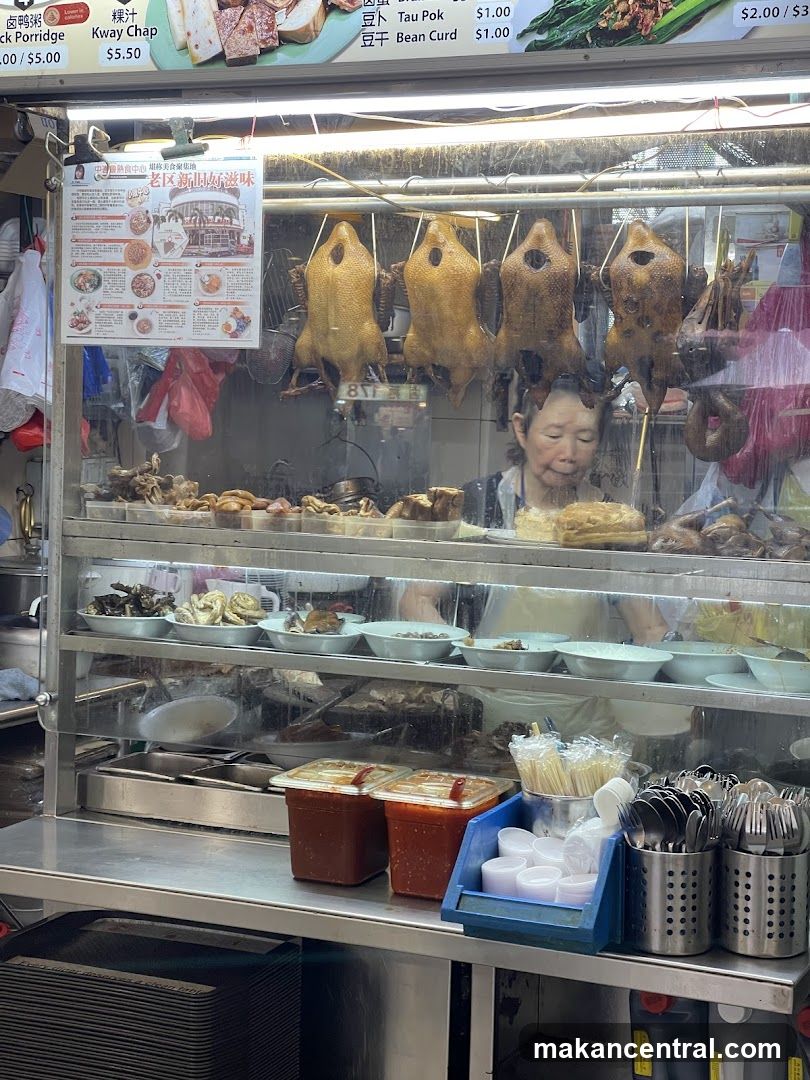 Food stall interior with roasted ducks and staff