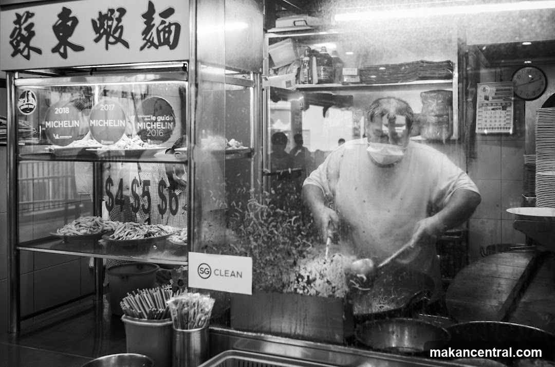 Food stall interior with chef cooking