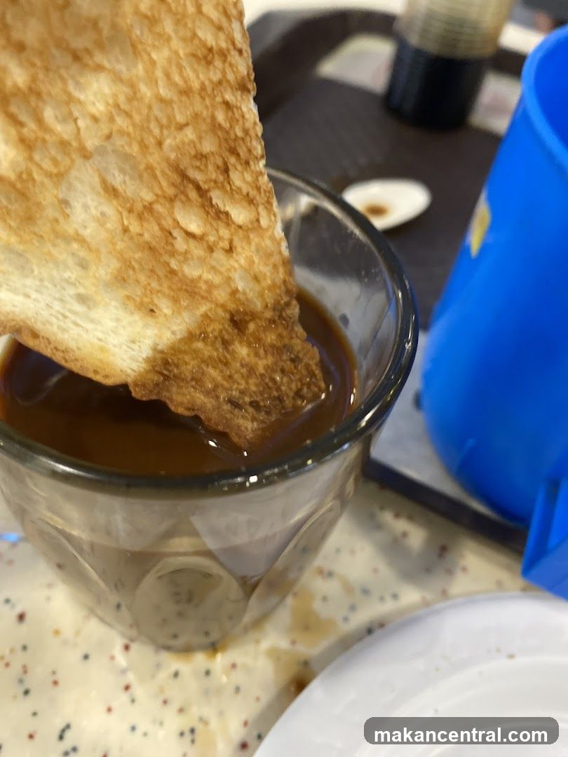Toasted bread dipping into coffee