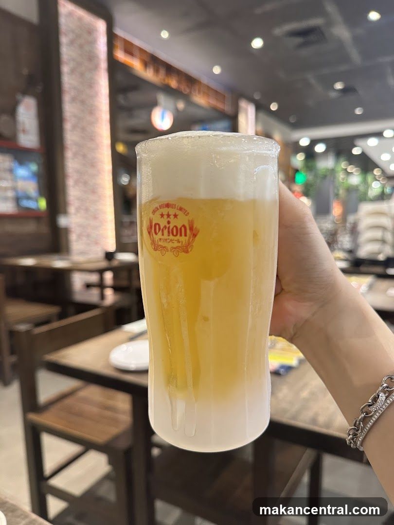 Hand holding beer glass in restaurant interior