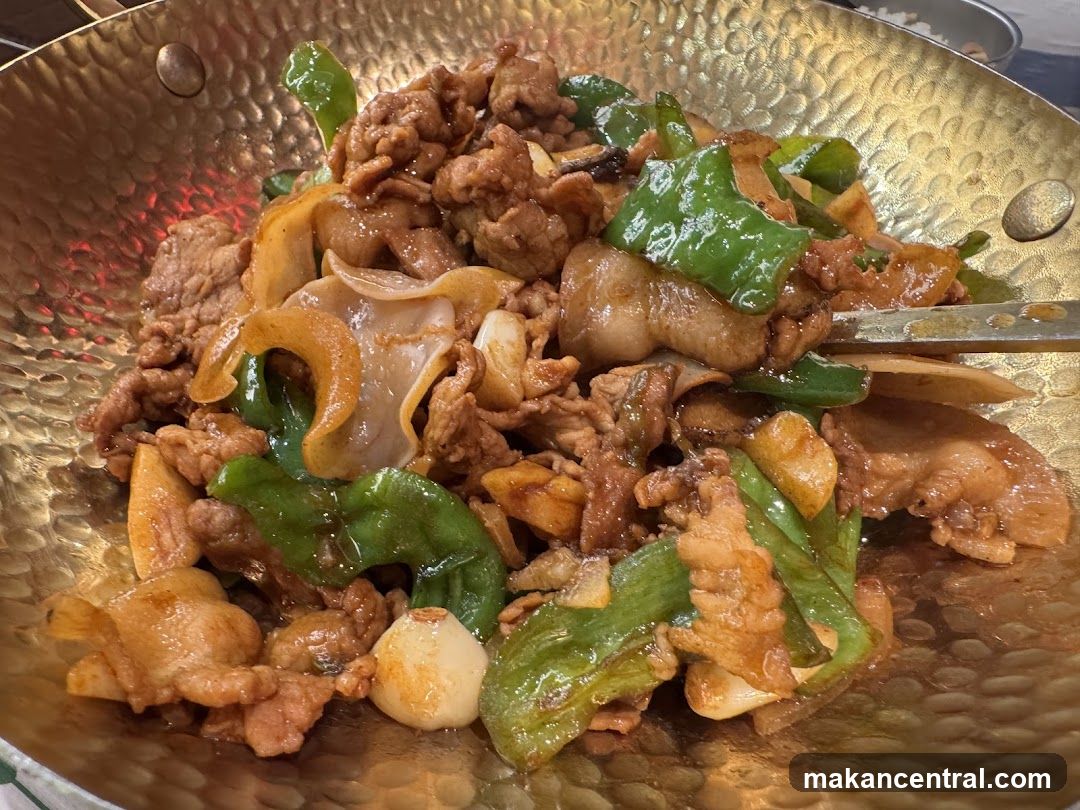 Stir-fried meat dish in a golden wok