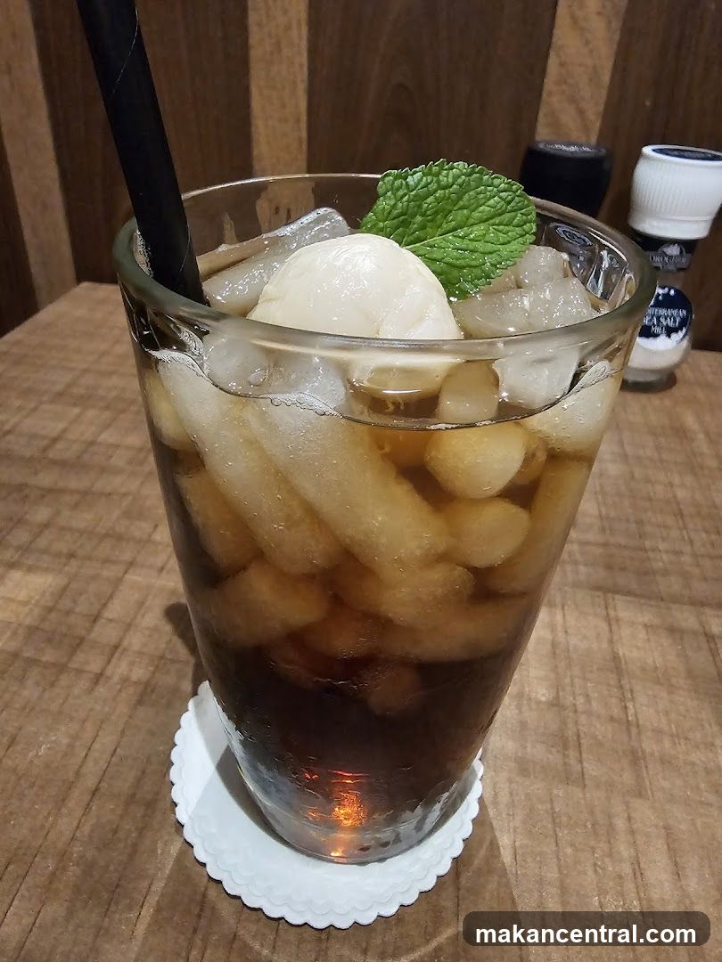 Iced beverage with mint garnish