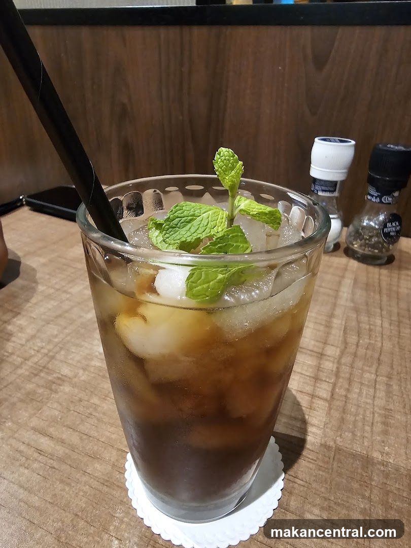 Iced beverage with mint garnish