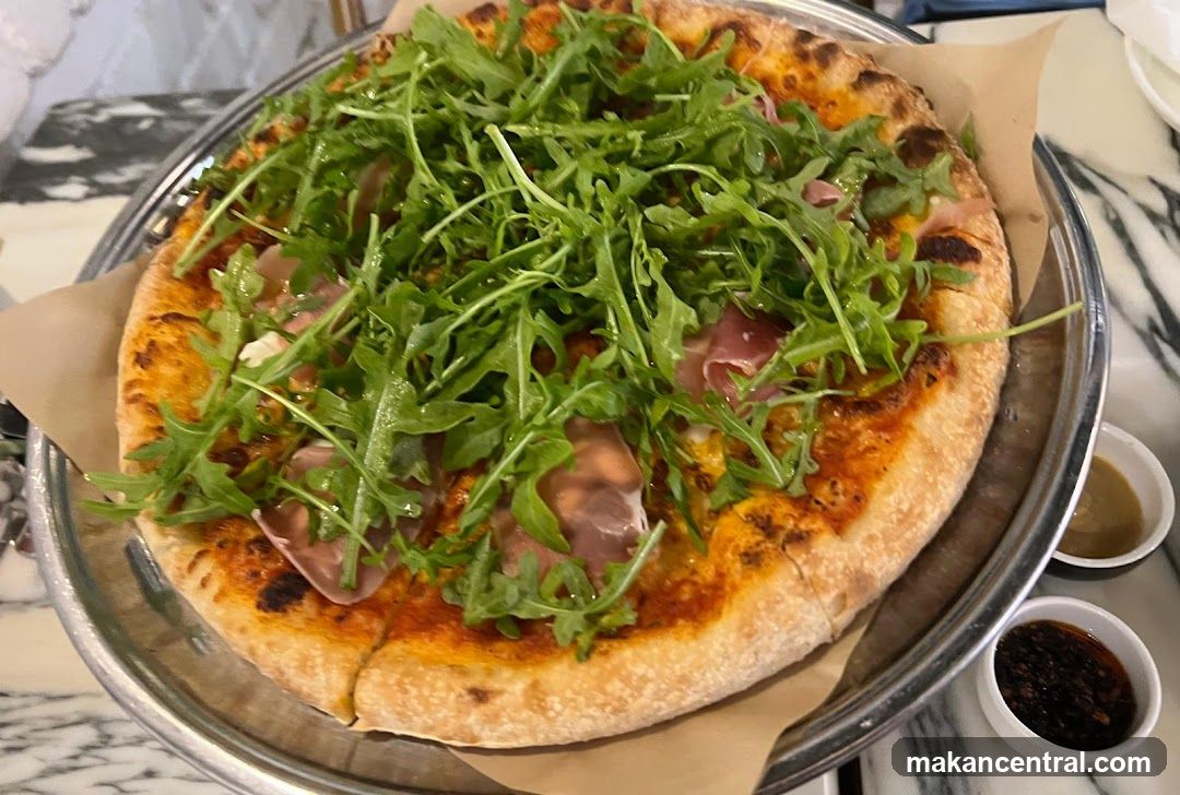 Pizza with arugula and ham