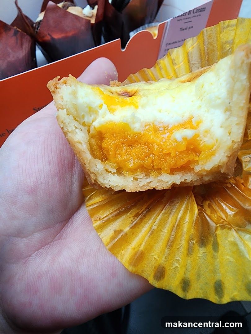 Hand holding a partially eaten pastry