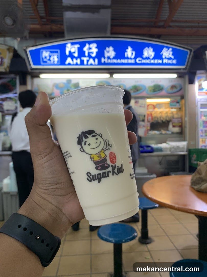 Hand holding Sugar Kid drink in food court