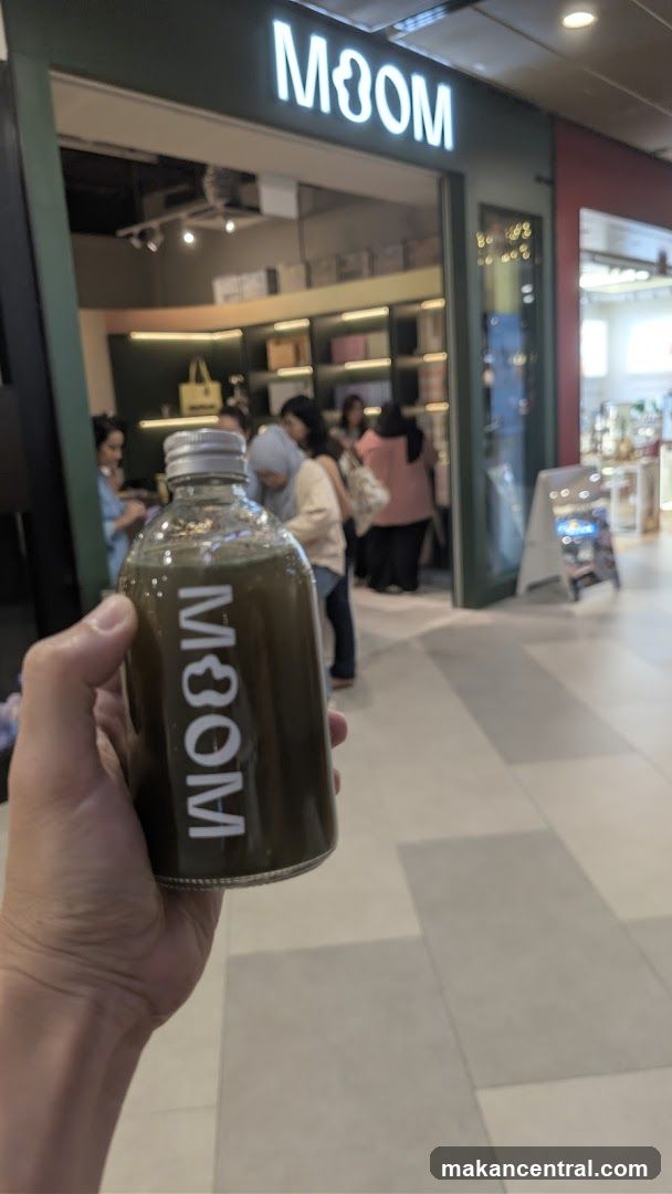Person holding a bottle with a logo