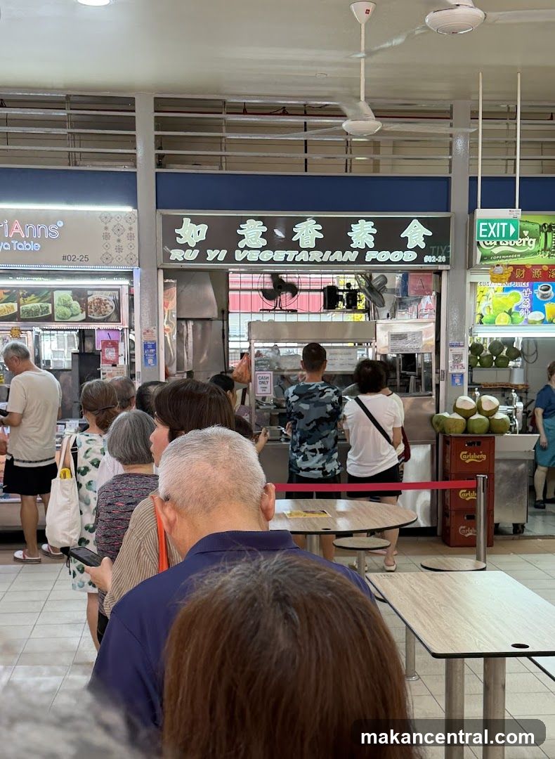 Interior of a hawker center with customers and food stalls