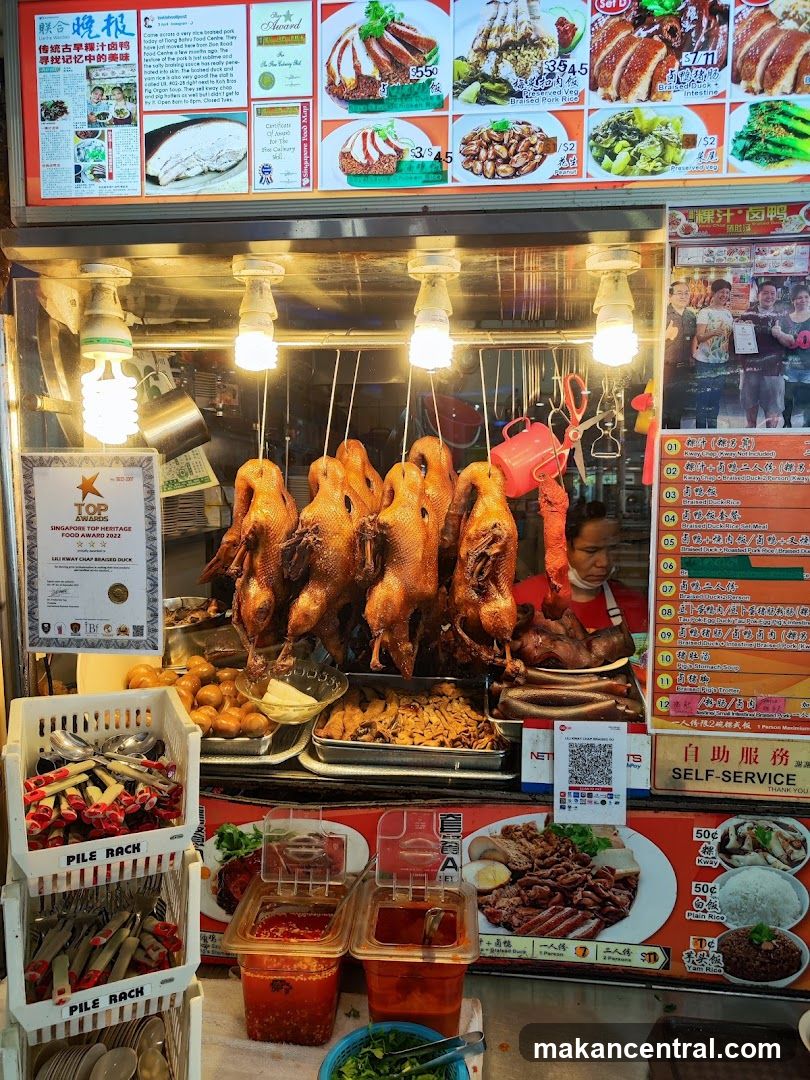 Food stall with roasted ducks and condiments