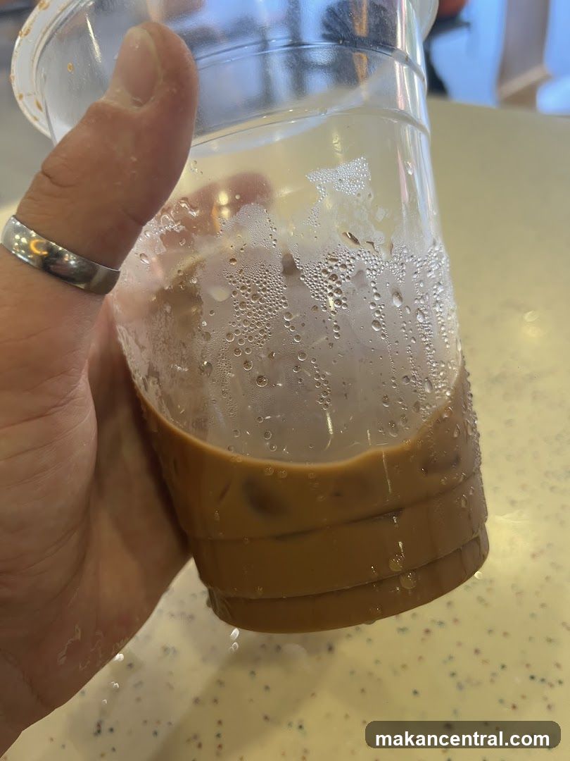 Hand holding iced beverage