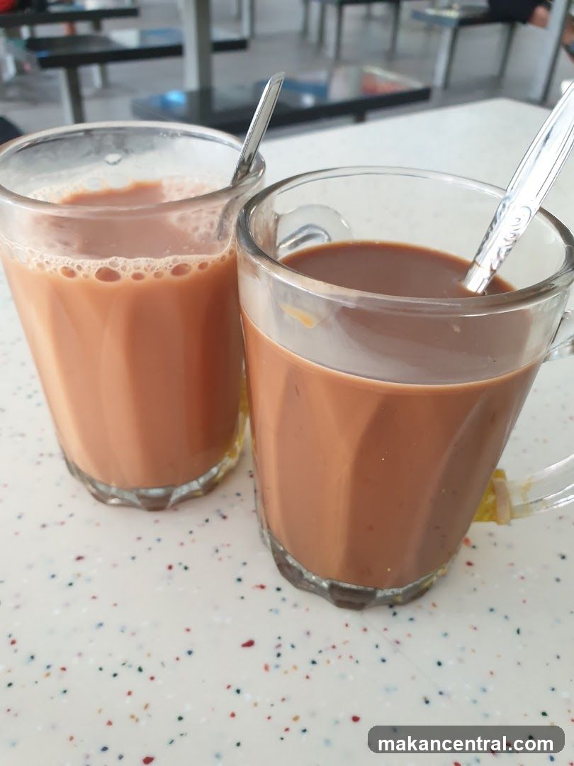 Two glasses of iced tea on a speckled table