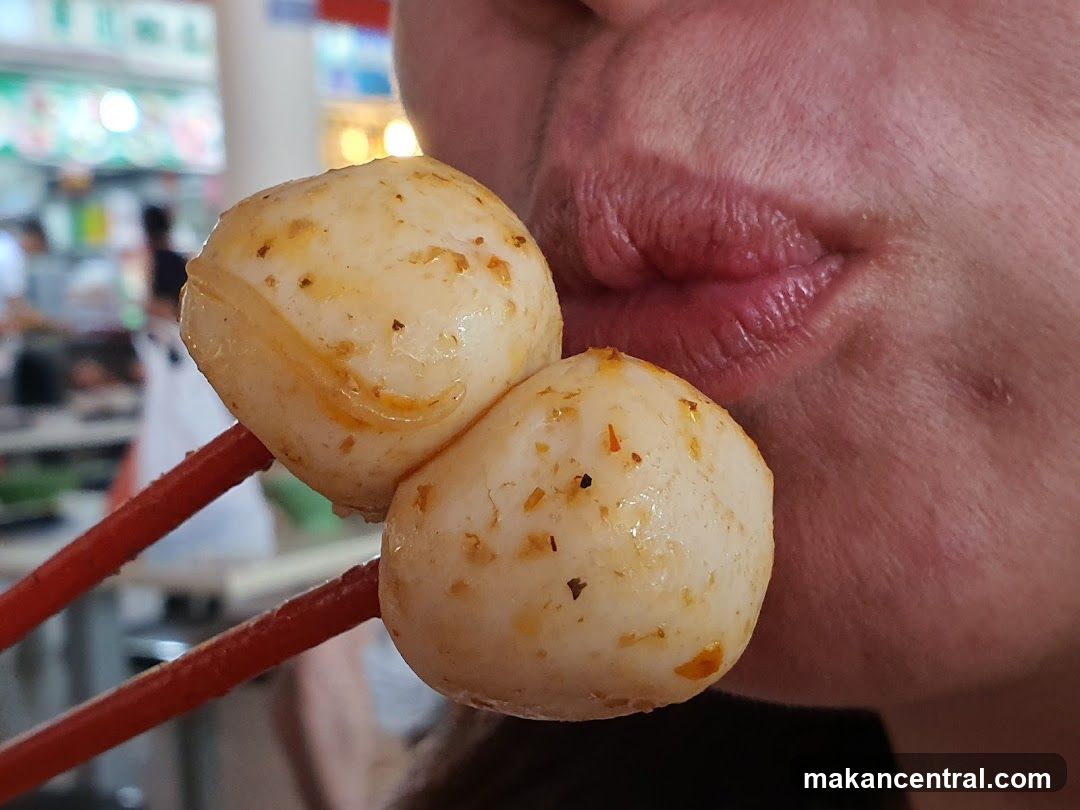 Person eating fish balls
