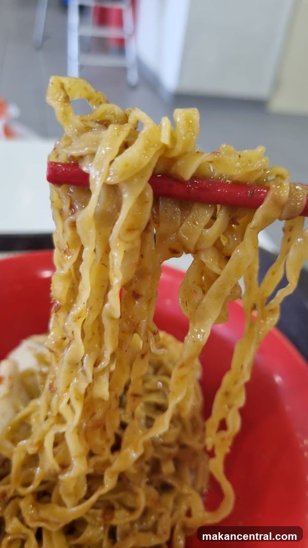 Noodles being lifted with chopsticks