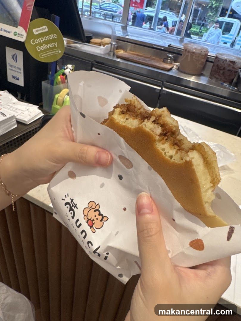 Pancake being held in paper wrapper