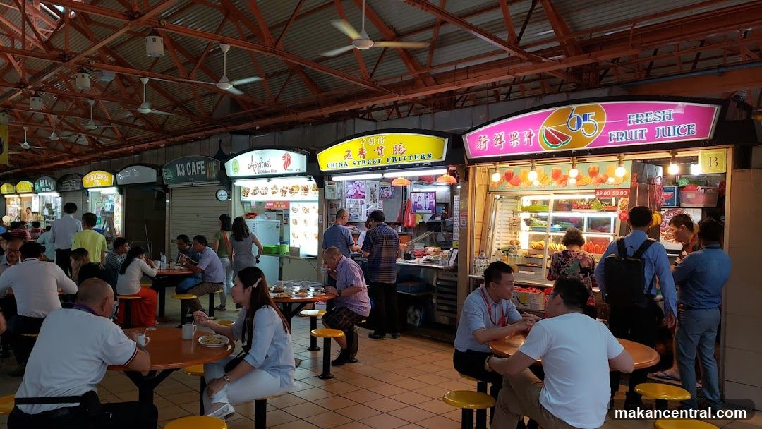 Food court with various stalls and diners