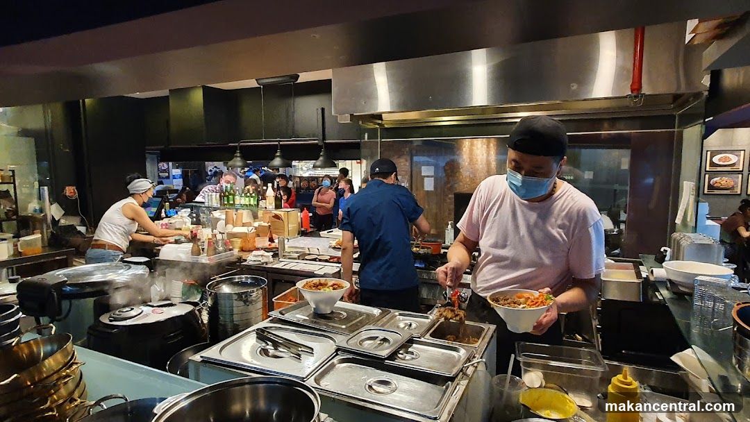 Chefs preparing food in a busy kitchen