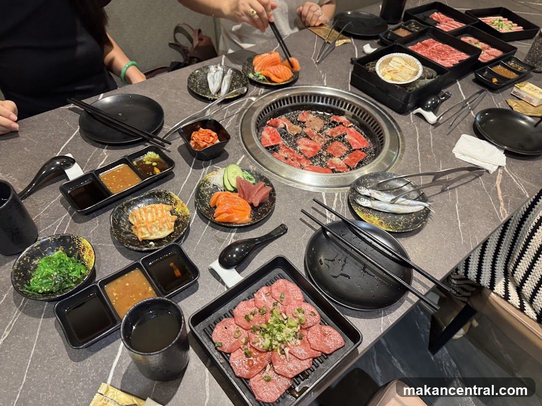 Table with grilled meat and various side dishes
