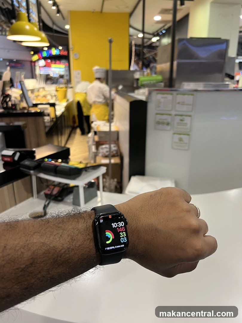 Person wearing a smartwatch in a food establishment