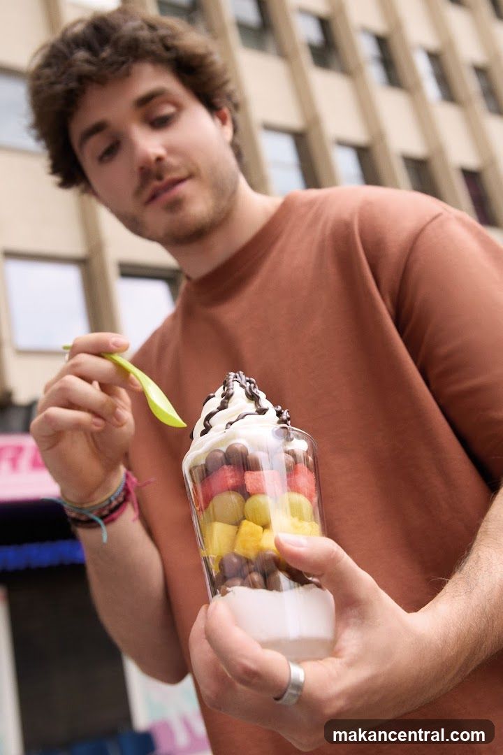 Man Eating a Fruit Parfait