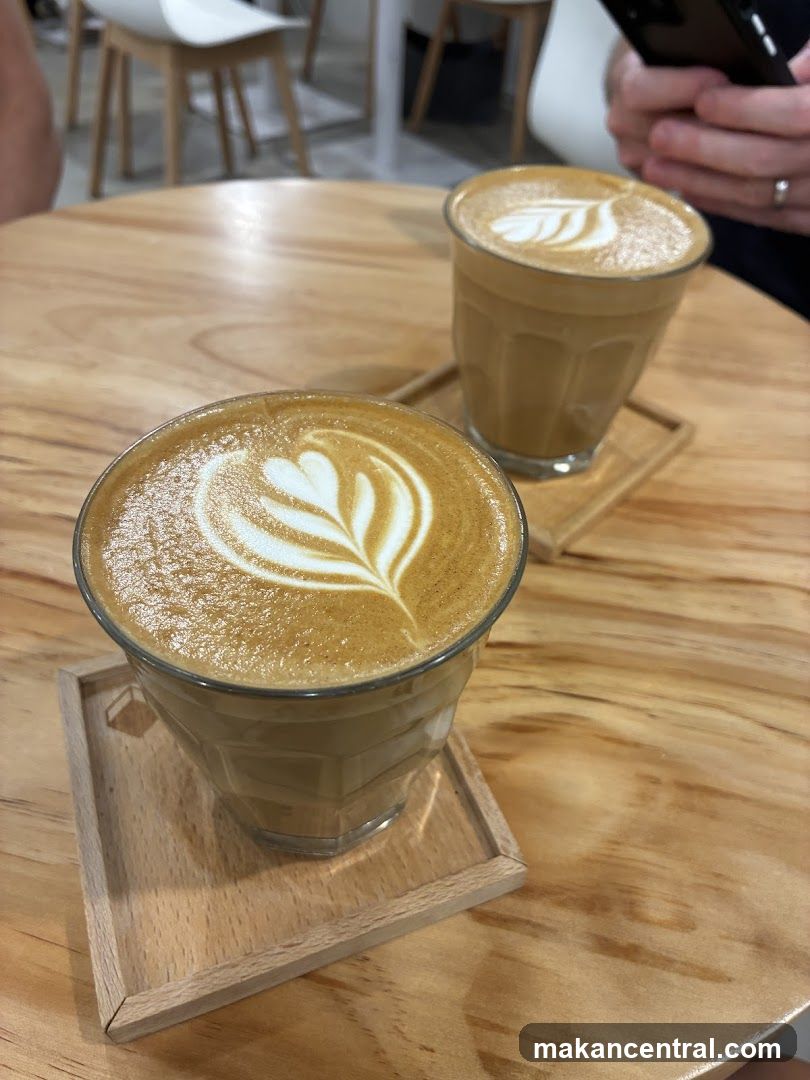 Two coffees with latte art on a wooden table