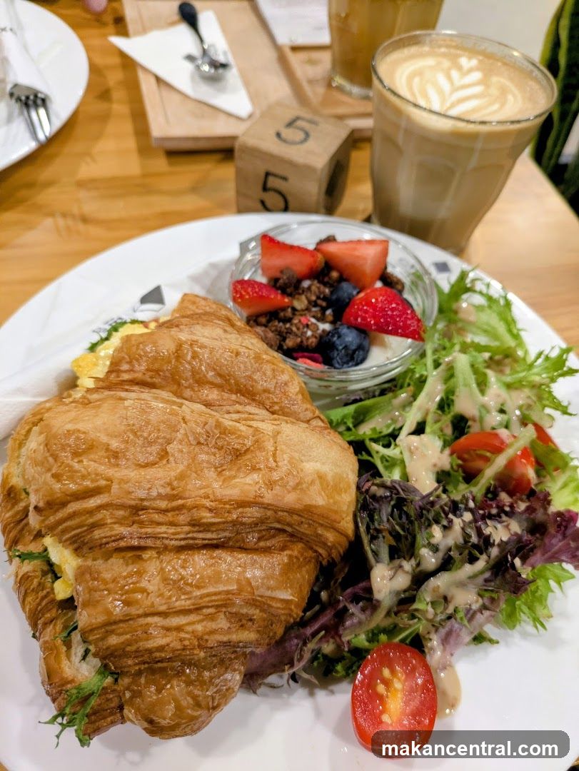 Croissant breakfast with fruit and coffee