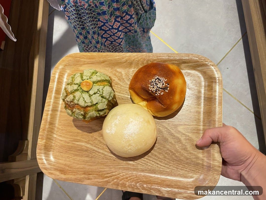 Three Pastries on a Wooden Tray