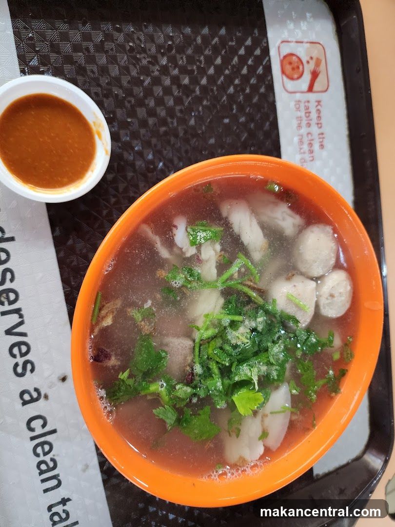 Bowl of soup with meatballs and herbs