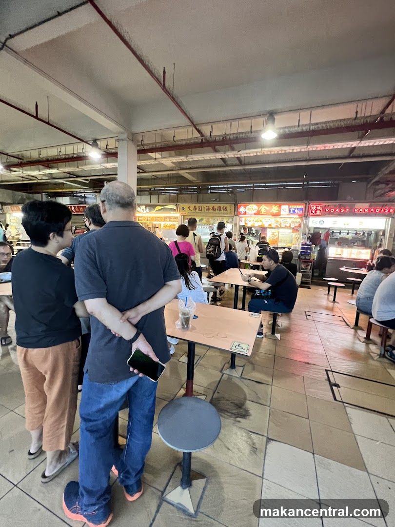 Food court with people dining and queuing