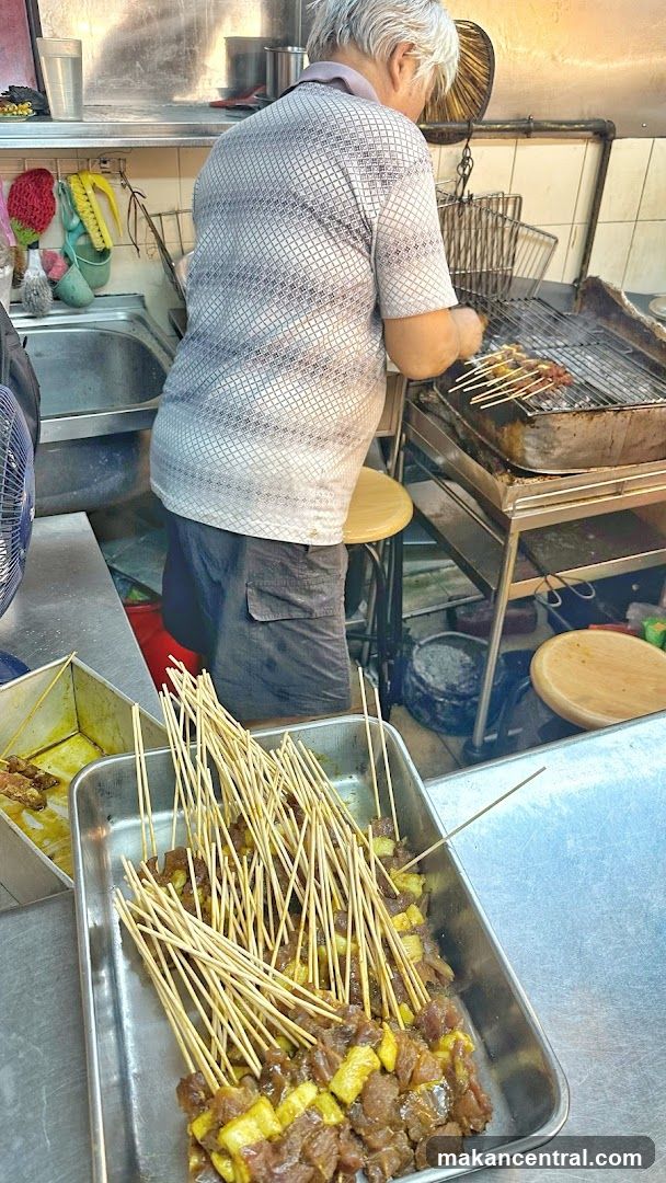 Man grilling skewers