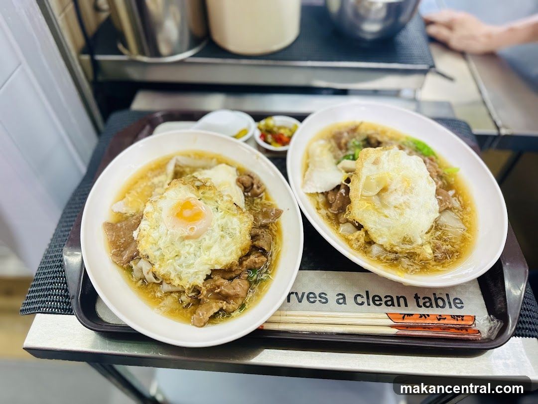Two bowls of noodles with fried eggs
