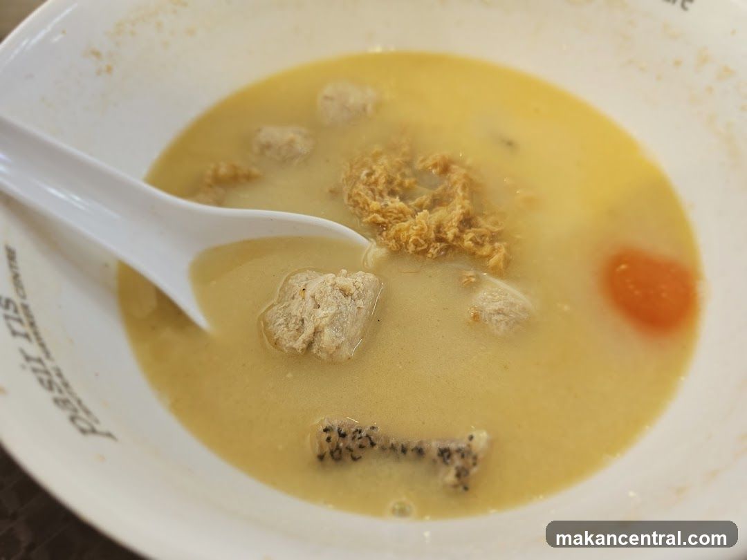 Bowl of Soup with Meatballs and Egg Yolk