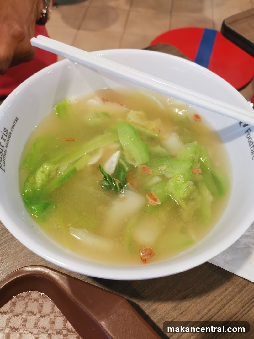 Bowl of Soup with Vegetables and Noodles