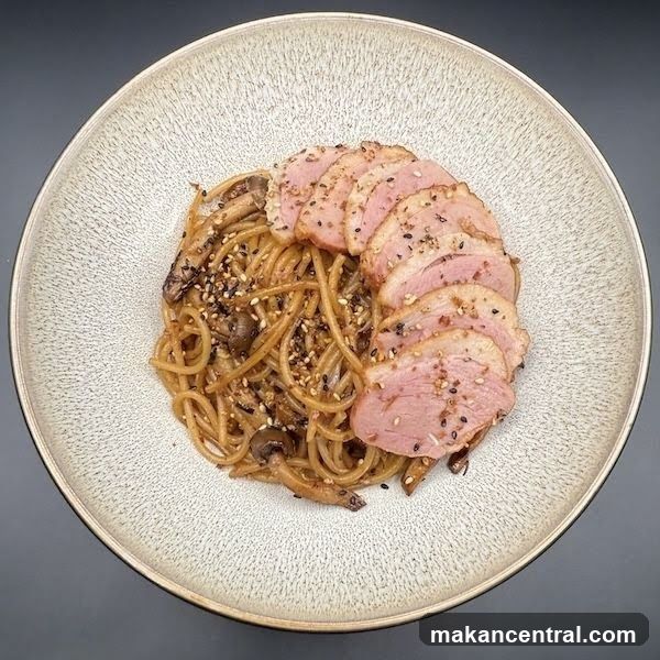 Sliced duck breast with noodles and mushrooms