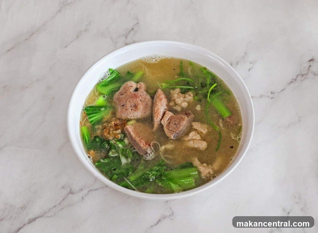 Bowl of Noodle Soup with Liver and Greens