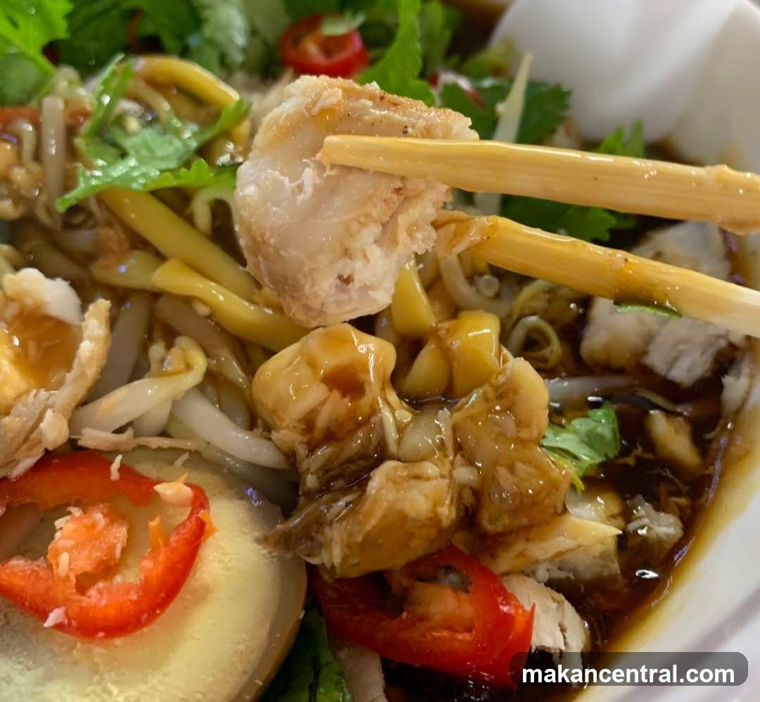 Close-up of a bowl of noodles with meat and vegetables