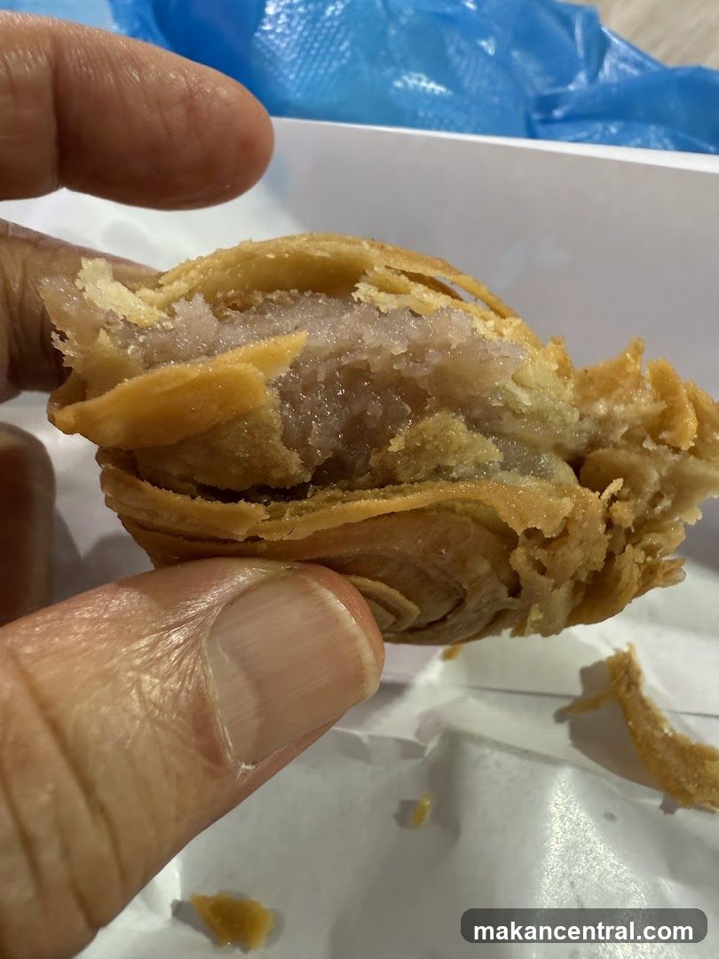 Close-up of a flaky pastry with a purple filling