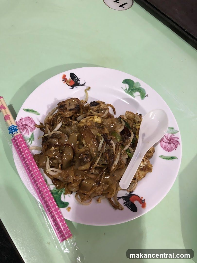 Plate of noodles with chopsticks and spoon