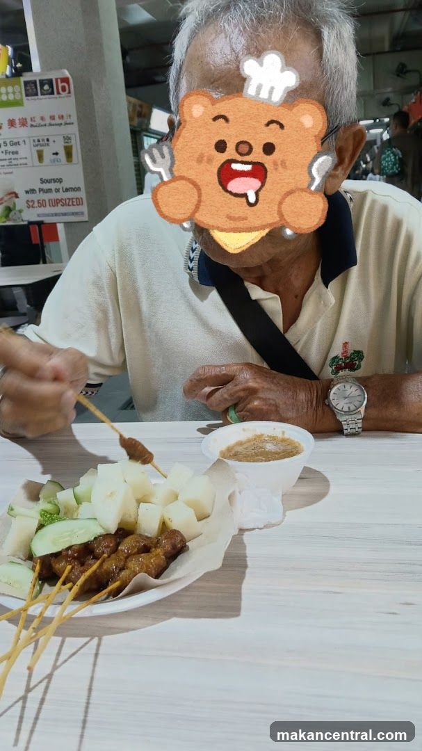 Man Eating Satay