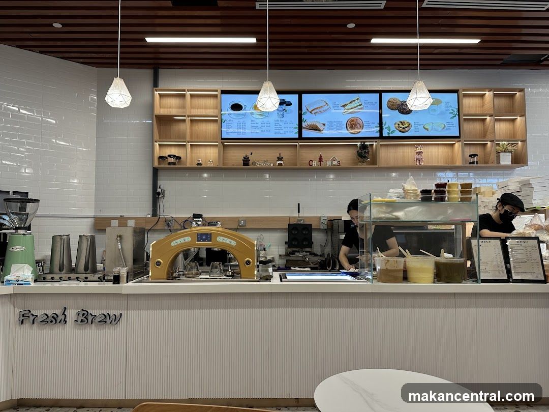 Coffee shop counter with menu and staff