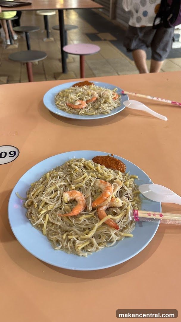 Two plates of noodles with shrimp