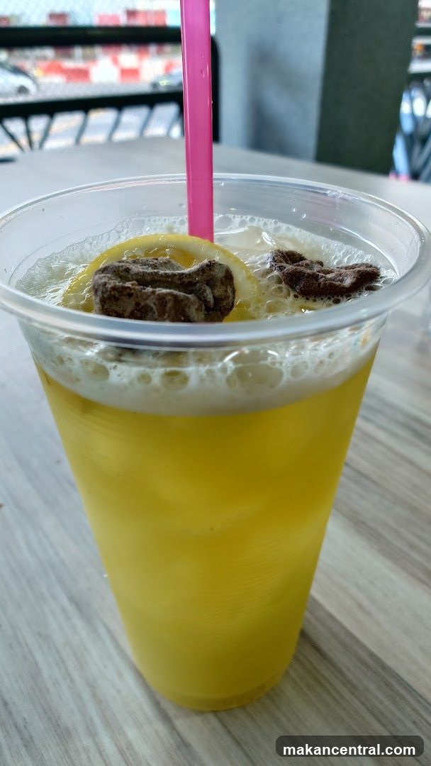 Yellow Drink with Lemon and Toppings
