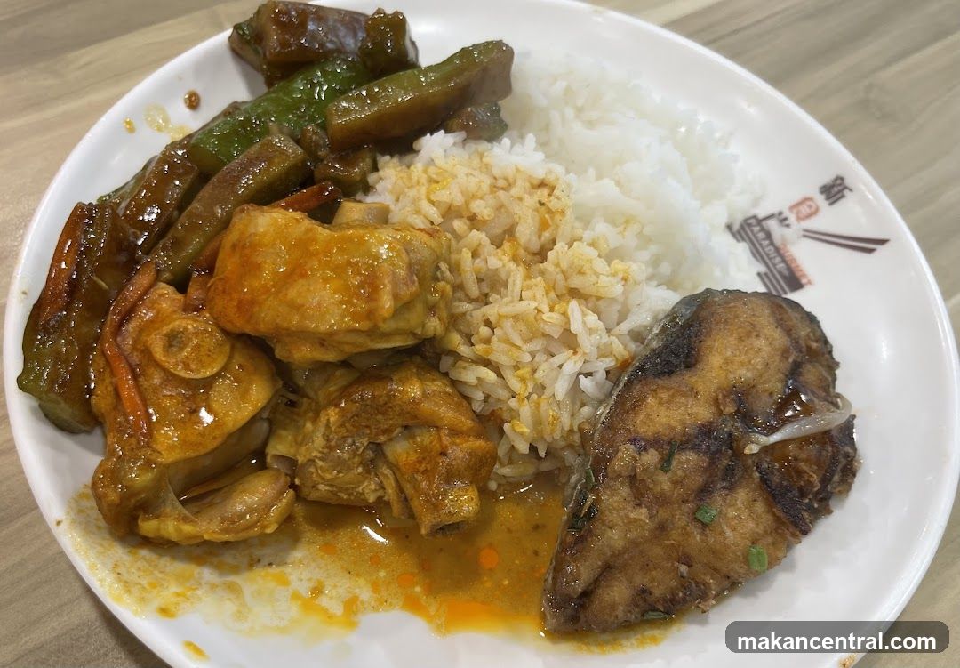 Plate of food with rice, chicken, fish, and vegetables