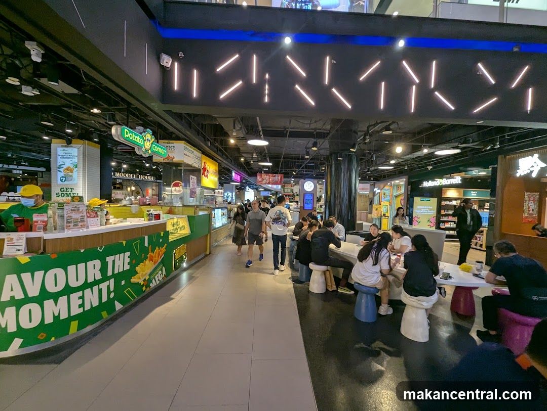 Food court with various stalls and seating areas